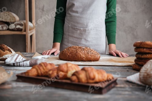 Preview: Cropped photo of young lady baker