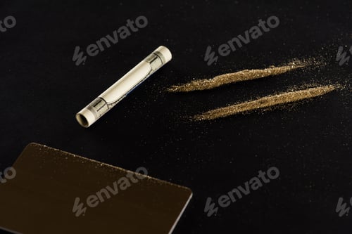 Preview: close up of golden credit card, dollar and powder lines isolated on black