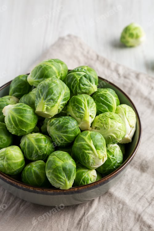 Preview: Raw Organic Brussel Sprouts in a Bowl, side view.