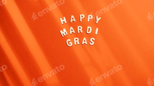 Preview: Happy Mardi Gras sign on orange Background