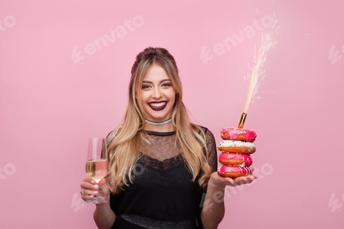 Preview: Delighted girl with wineglass and sparkler