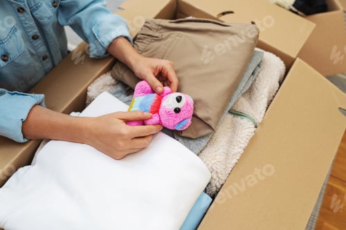 Preview: Charitable giving concept, packing children's toy and clothes for donation. Concept of hope.