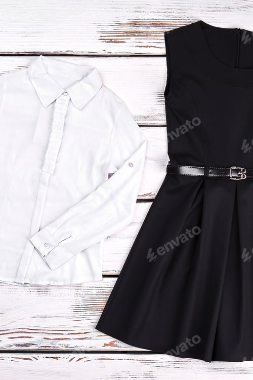 Preview: White Blouse and Black Dress Laying Flat