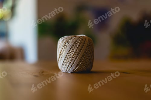 Preview: Roll of cotton yarn on a table.