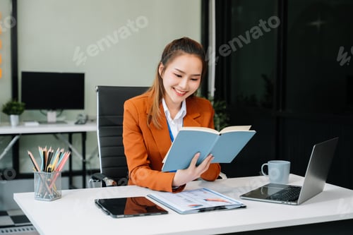 Preview: Asian businesswoman working in the office with working notepad, tablet and laptop documents