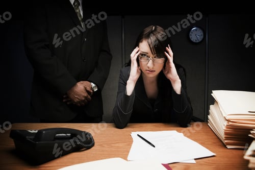 Preview: Boss behind stressed woman at desk