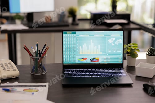 Preview: Laptop computer displaying graphs and charts