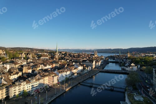 Preview: Aerial view of Zurich cityscape with historic buildings, river, and distant mountains