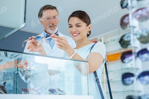 Preview: Nice pretty woman checking the sunglasses in her hands
