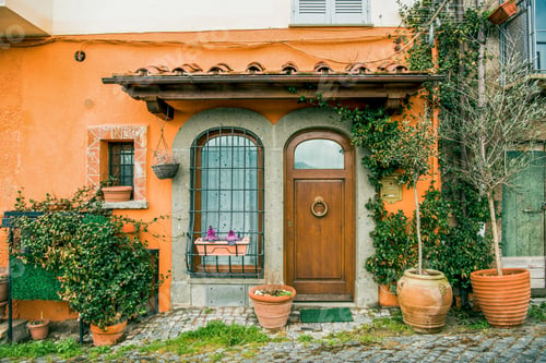 Preview: facade of beautiful building with potted plants and flowers in Castel Gandolfo, Rome suburb, Italy