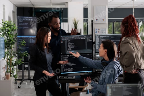 Preview: Multi ethnic web developers writing script while talking