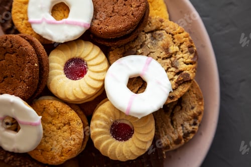 Preview: Variety of Biscuits on a pink Plate, top view. Flat lay, overhead, from above. Copy space.
