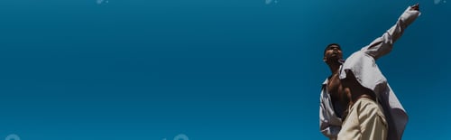 Preview: low angle view of trendy african american man with outstretched hand under cloudless sky, banner