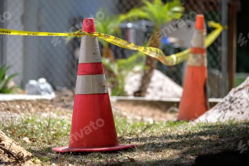 Preview: Yellow warning cones and tape as protective restriction barrier at industrial construction