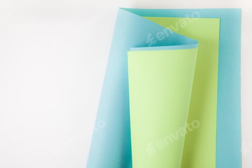 Preview: blue and green paper sheets on grey background