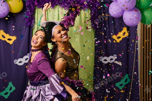 Preview: Carefree women having fun while dancing at Mardi Gras party.