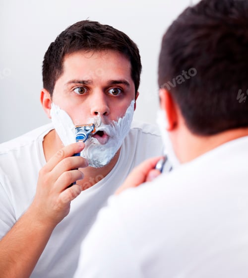 Man Shaving His Face in the Mirror