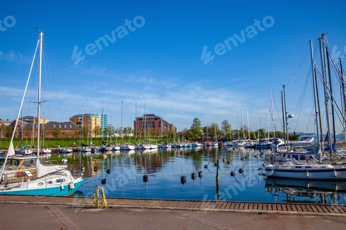 Preview: yachts and boats moored at harbor with calm water in copenhagen, denmark