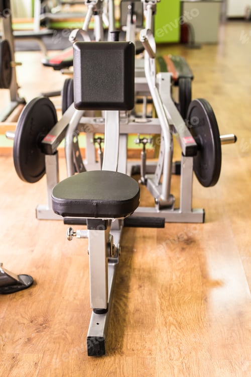 Preview: Sport, training and healthy lifestyle concept - gym interior with equipment