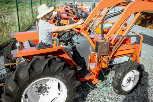 Preview: Agronomist choosing tractor at the agricultural shop