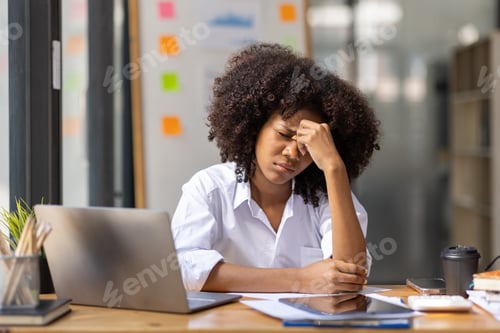 Preview: Portrait of tired young business african american woman work with documents tax laptop computer in