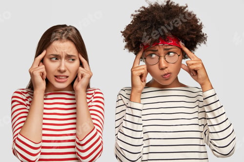 Preview: Displeased frustrated girls keep index fingers on temples, try to recollect information in mind, dre