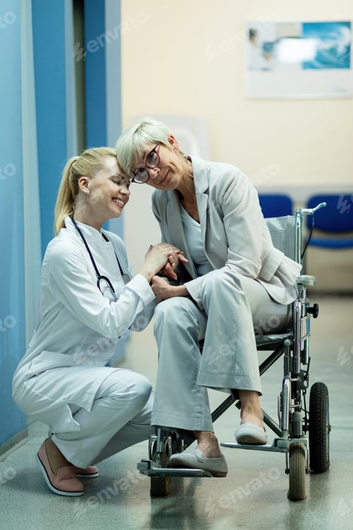 Preview: Caring female nurse and her disabled mature patient at clinic.