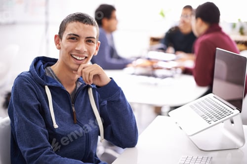 Preview: Cropped shot of a handsome young man working on his laptop in an office