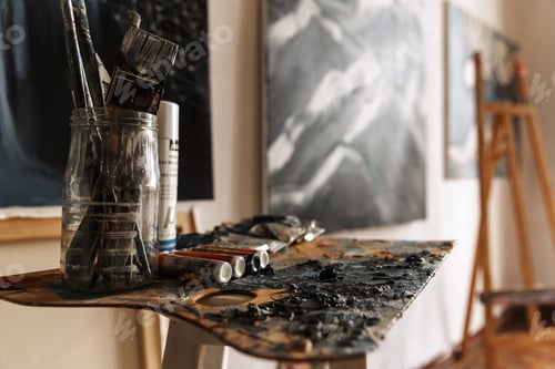 Preview: Image of artist workplace with painting tools and artworks on wall