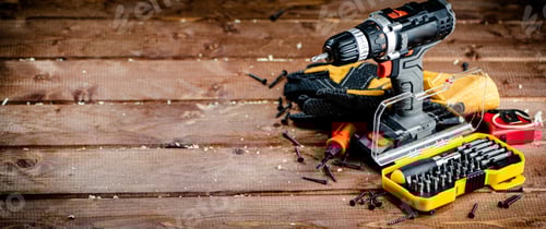 Preview: Cordless Drill and Tools on a Wooden Surface