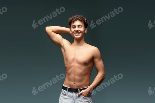Preview: Smiling, attractive with bare torso, muscles body, fashion model posing isolated on gray background