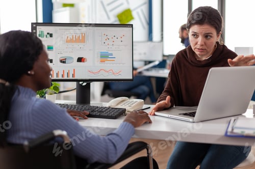 Preview: Paralyzed handicapped african american manager in wheelchair analyzing company statistics