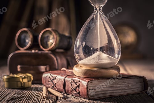 Preview: Vintage journal and hourglass as a concept of journey memories
