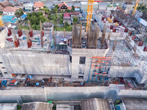 Preview: Aerial view of busy industrial construction site workers working. Development high rise building.