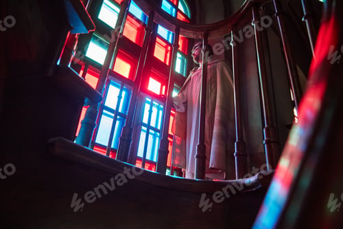 Preview: Priest Standing near Stained Glass Window in Church