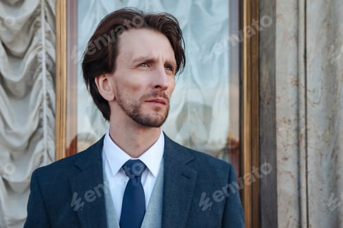 Preview: Portrait stylish adults man in suit on balcony