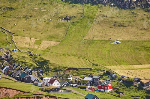 Preview: Helicopter flying over mykines village in Faroe. Denmark