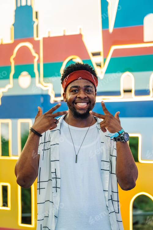 Preview: Young tourist gesturing peace sign, enjoying colorful city landmark