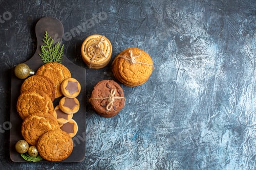 Preview: top view different tasty biscuits on light-dark background christmas sweet new year sugar cookie