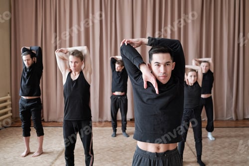 Preview: Group of guys and girls in black t-shirts and pants practicing dance exercise