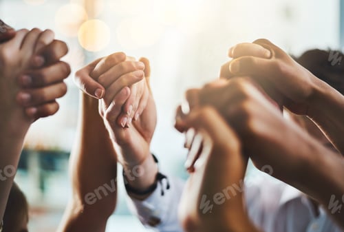 Preview: Closeup shot of a group of businesspeople holding hands together in solidarity