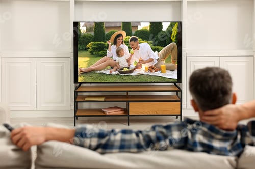 Preview: Man watching movie on TV set at home