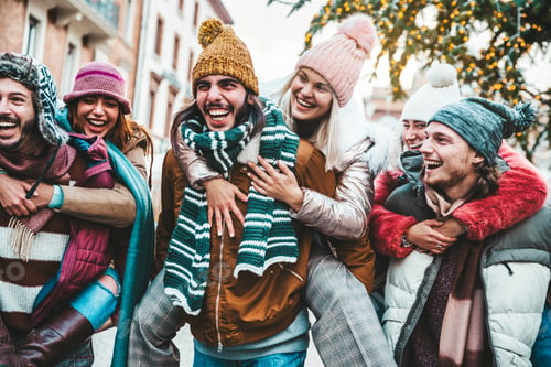 Preview: Happy group of friends wearing winter clothes having fun celebrating Christmas day together