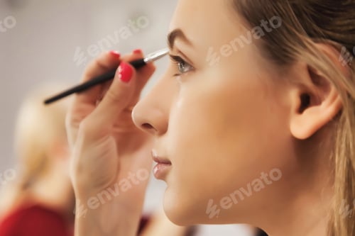 Preview: Makeup artist makes up for pretty woman in beauty salon, make eyebrow