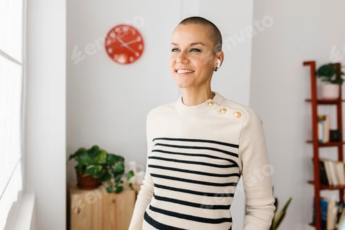Preview: Empowered mid adult businesswoman standing at office workplace