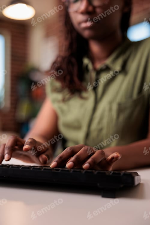 Preview: Closeup of african american woman programmer writing code on computer keyboard