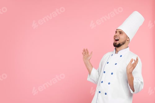 Preview: Excited professional confectioner in uniform on pink background. Space for text