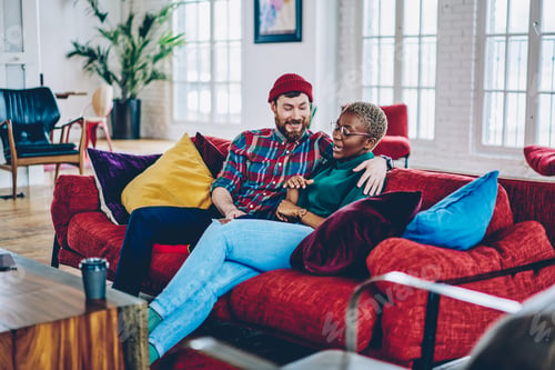 Preview: Emotional couple in love enjoying live communication and romance relaxing on sofa