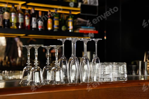 Preview: Different empty clean glasses on counter in bar