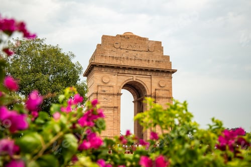Preview: India Gate framed by bougainvillea flowers in New Delhi, India